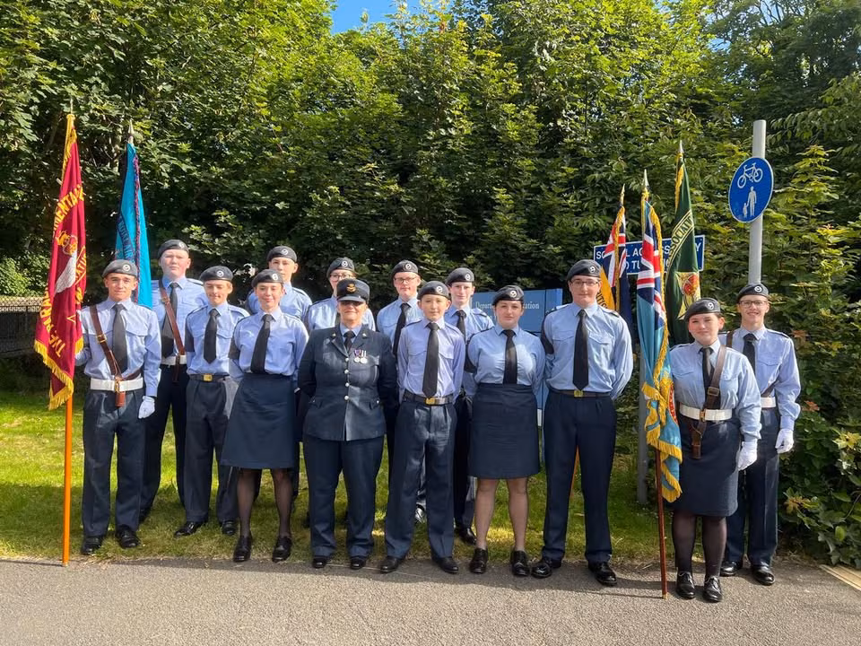 440 Squadron cadets standing with the squadron colours